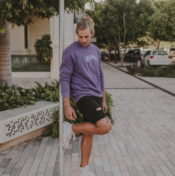 man wearing purple haze lazy sundae logo jumper