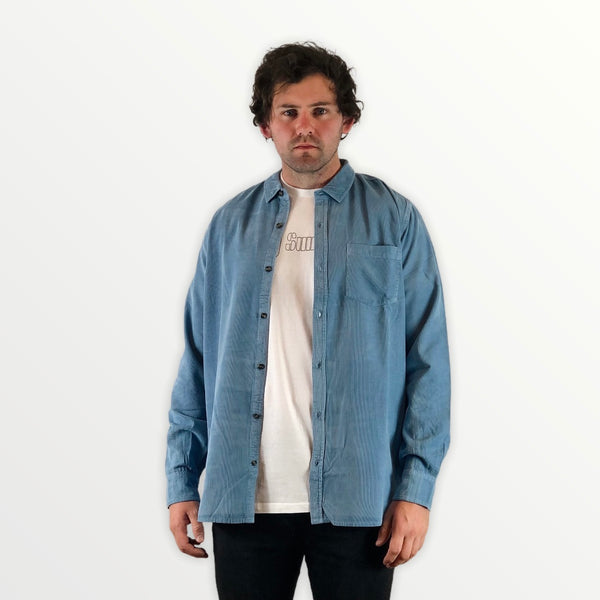 man wearing blue long sleeve button up shirt
