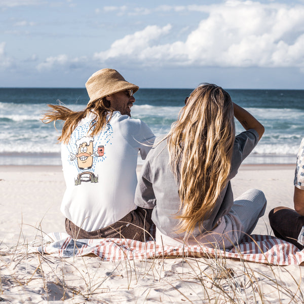 surfer couple at the beach wearing lazy sundae clothing